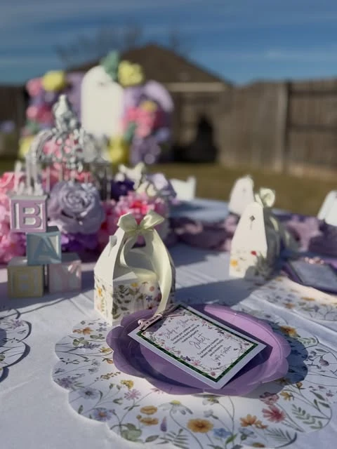 Wildflower theme baby shower tablescape with printed placemat and favor box.