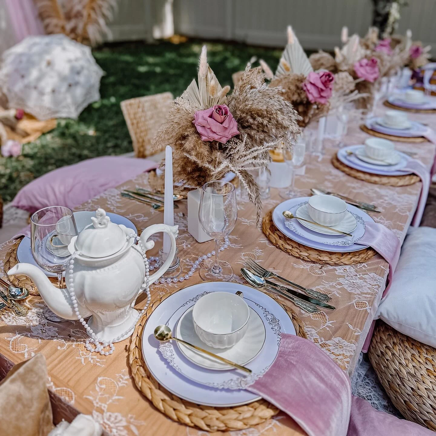 A of a tea party tablescape with a white teapot and woven placemats.