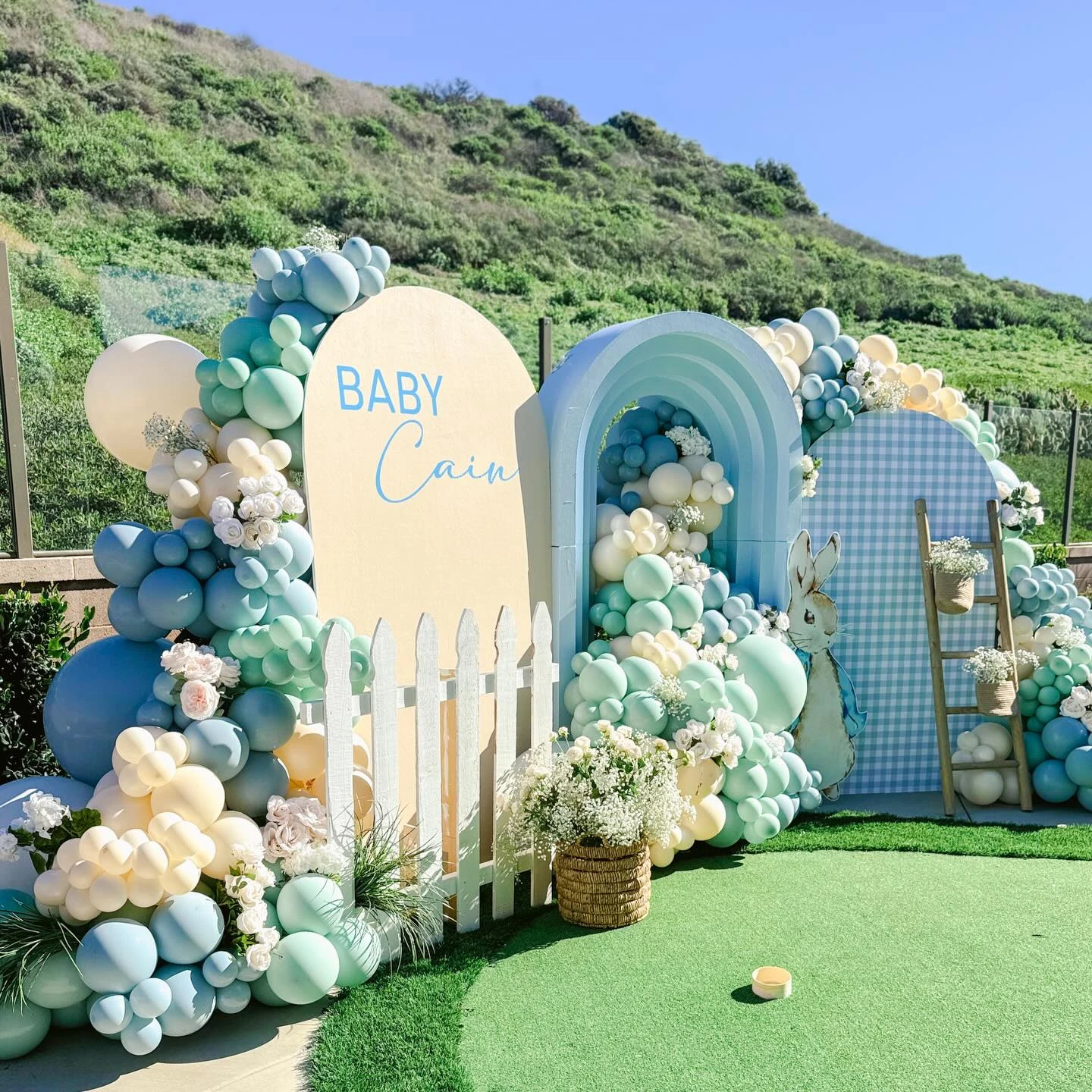 Layered arched backdrops for a Peter Rabbit baby shower.