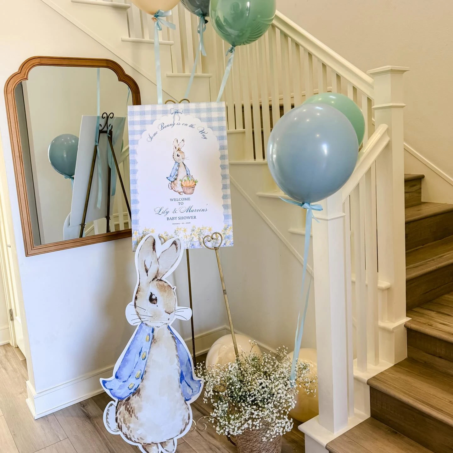 Peter Rabbit baby shower welcome sign and cutout at an entryway.