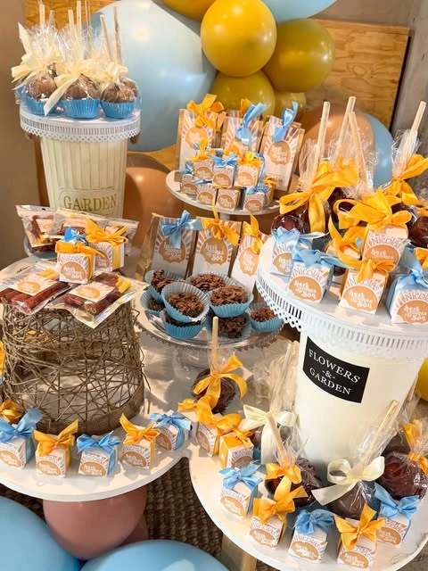 A dessert table for a 'Here comes the Son' baby shower with coordinated favors and decor.