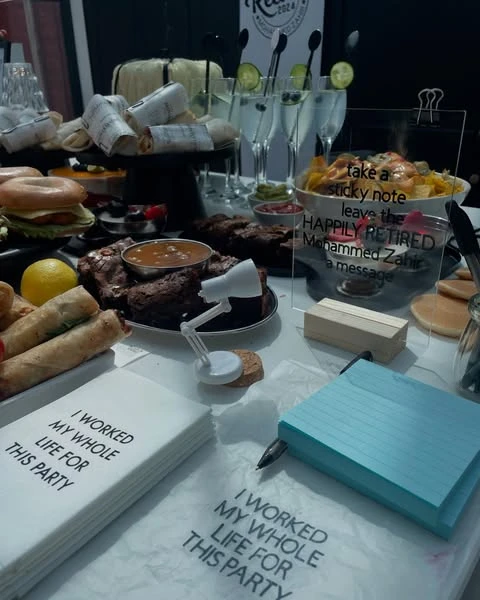 A sticky note station at a retirement party for guests to leave messages for the retiree.