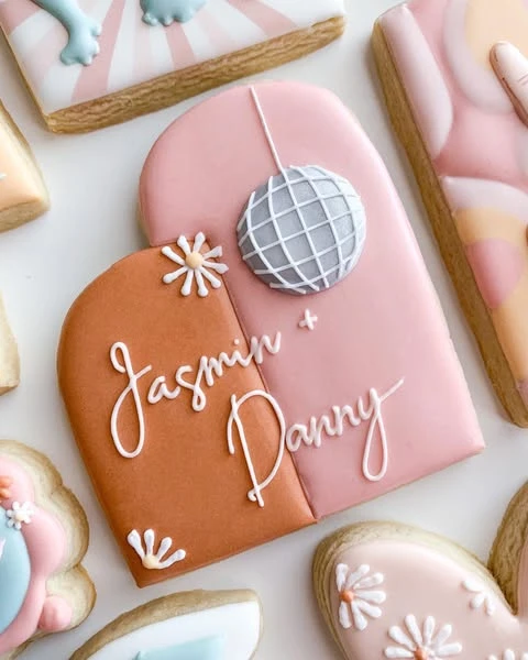 Personalized Mamma Mia bachelorette cookie with a disco ball and custom names.