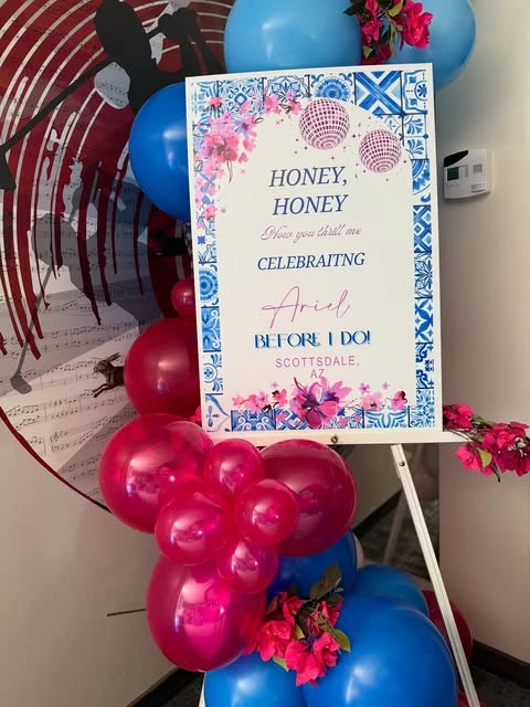 A personalized Mamma Mia themed welcome sign for a bachelorette party on an easel.