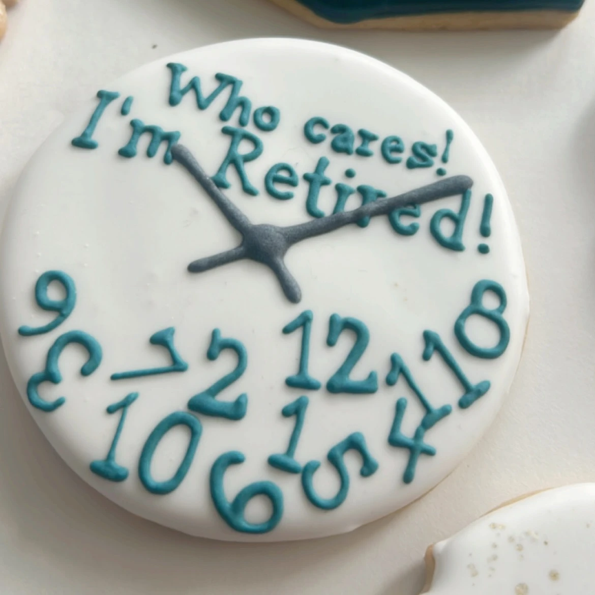 Retirement clock cookie with jumbled numbers and the phrase 'Who cares! I'm Retired!'