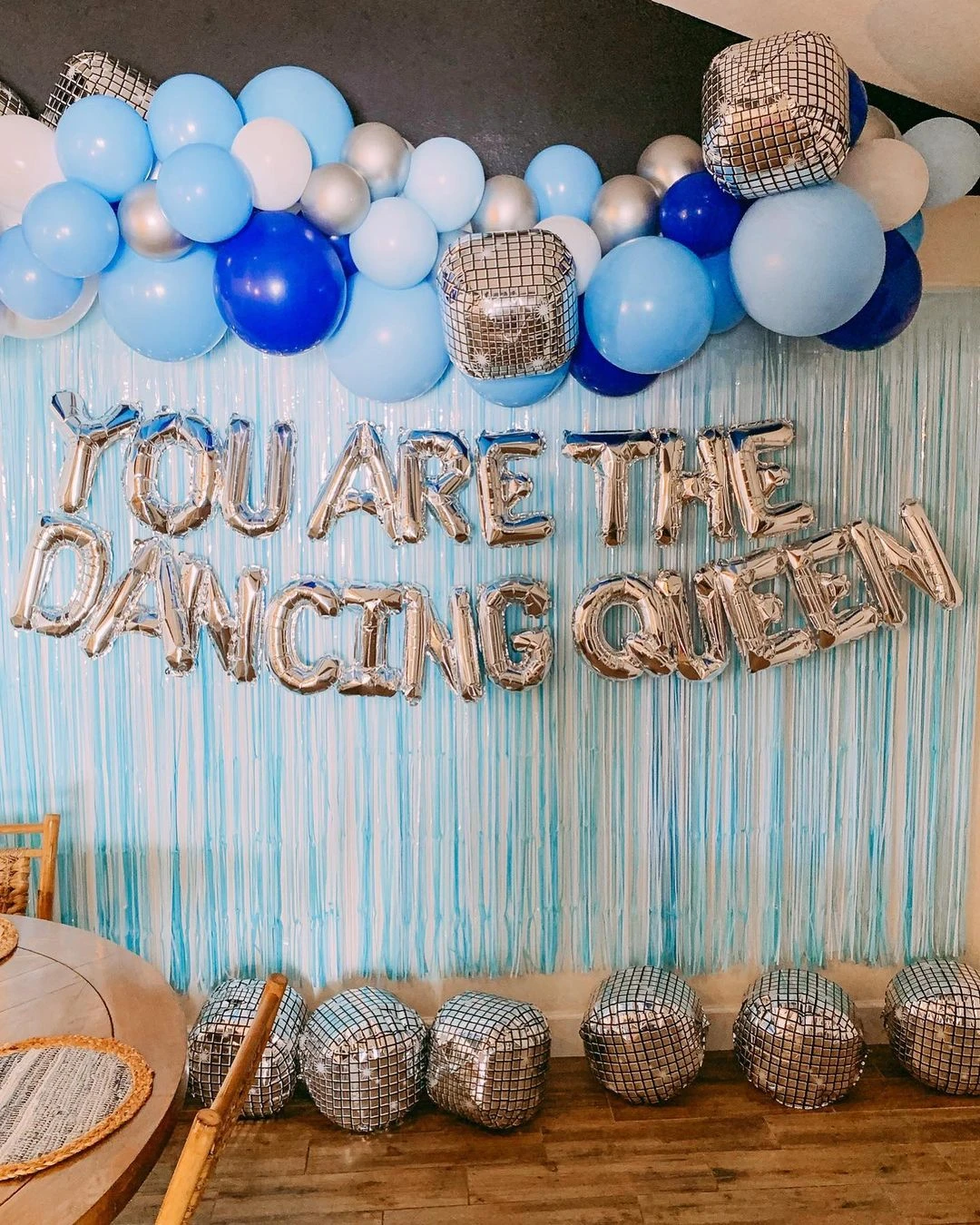 Mamma Mia bachelorette party photo backdrop with a blue and white balloon garland and a 'Dancing Queen' silver balloon banner.