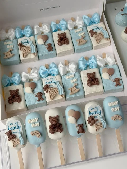 Boxed 'we can bearly wait' cakesicles and treats ready to be used as baby shower favors.