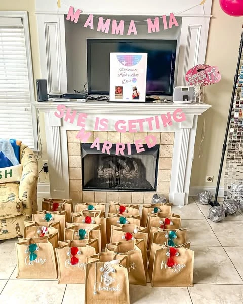 Personalized kraft paper party favor bags with colorful tassels for a Mamma Mia bachelorette party.