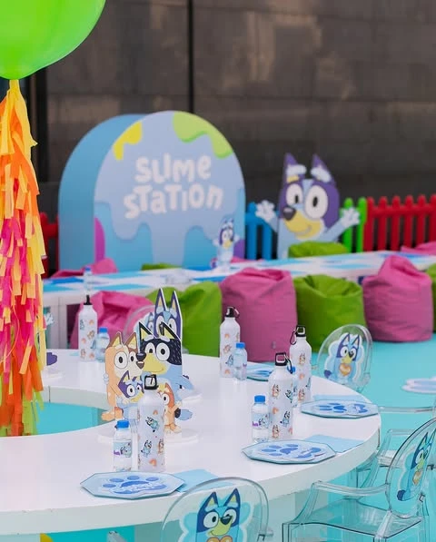 A Bluey-themed 'Slime Station' activity area at a children's birthday party.