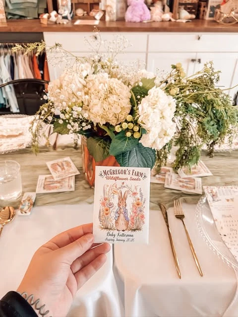 Hand holding a custom Peter Rabbit wildflower seed packet party favor.