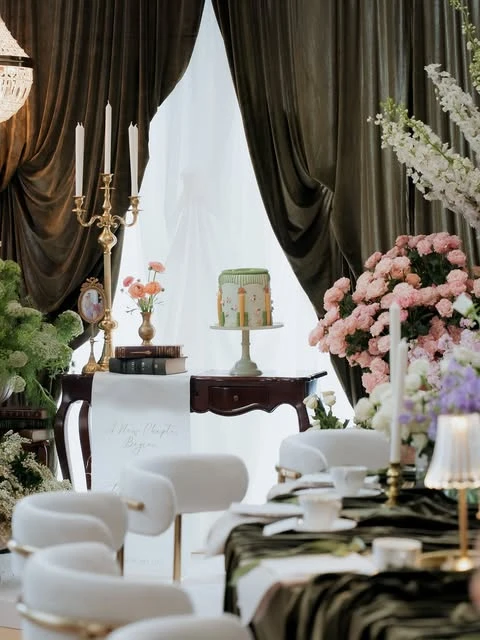 A dessert table at a literary-themed bridal shower, showing a cohesive design with the main dining area.