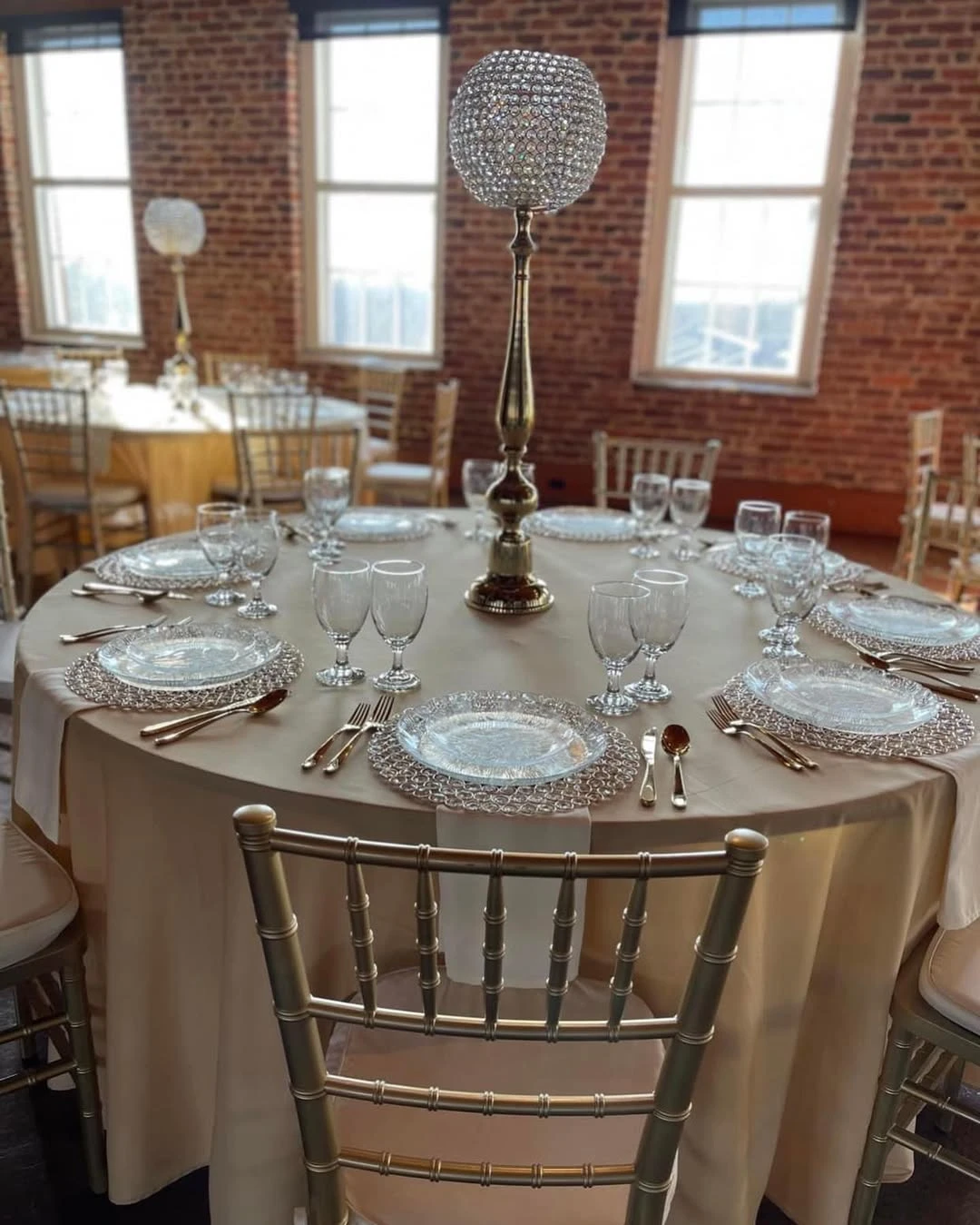 Tan military boot on a gold pedestal used as a vase for a floral centerpiece at a retirement party.