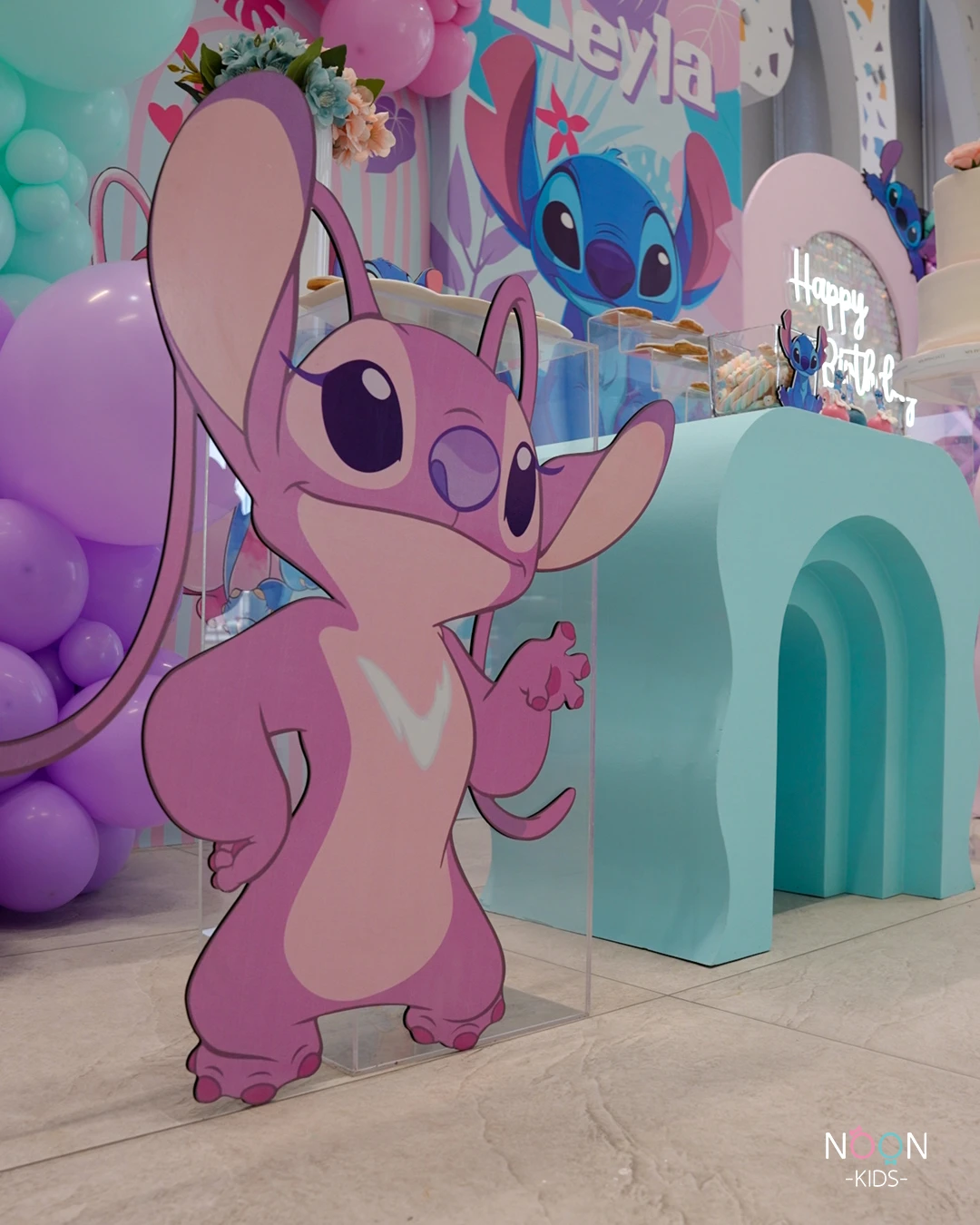 Life-sized character cutout of Angel from Lilo & Stitch at a birthday party.