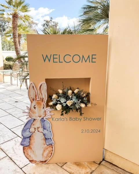 Modern Peter Rabbit baby shower welcome sign with a fresh flower insert.