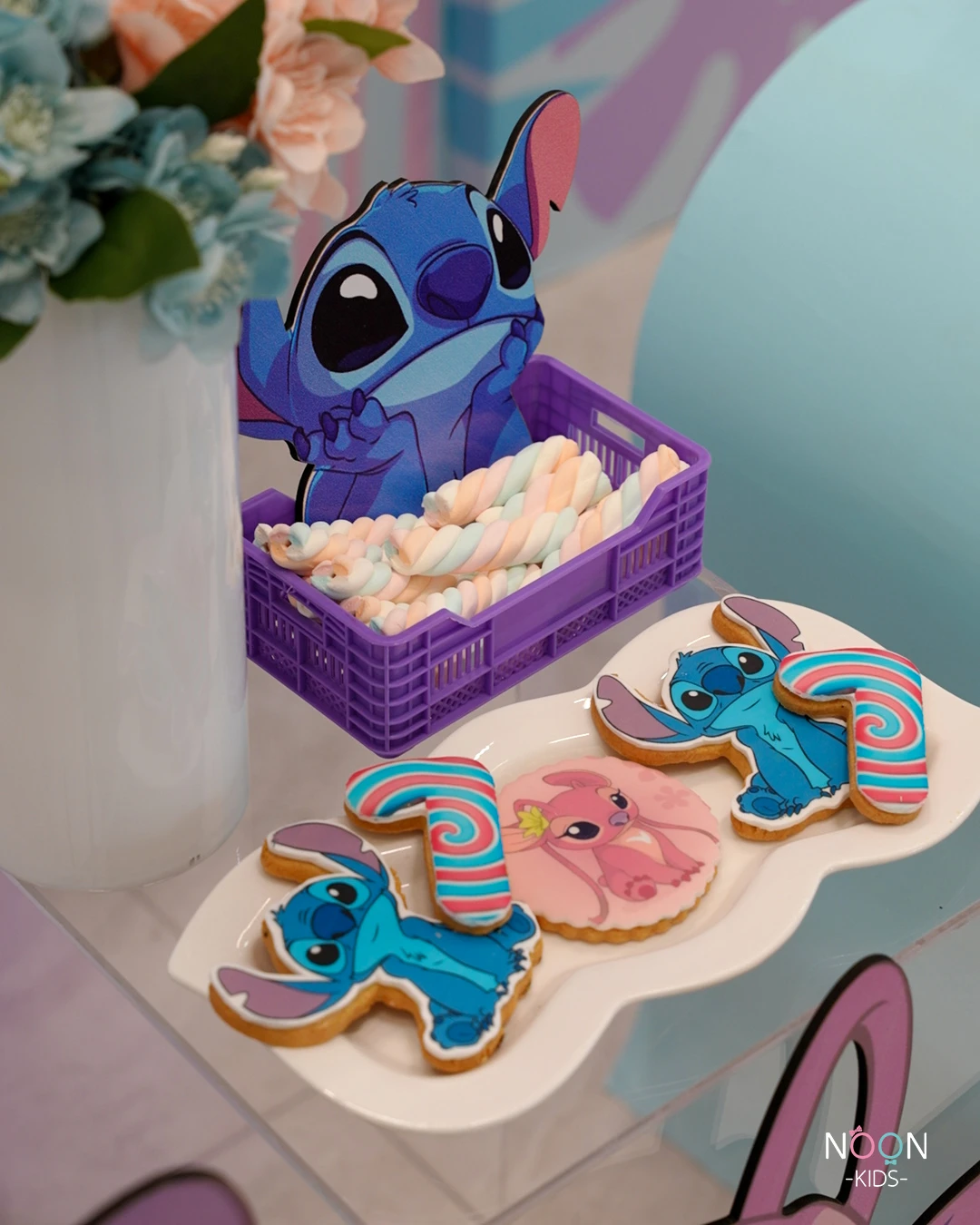 custom sugar cookies shaped like Stitch and Angel.