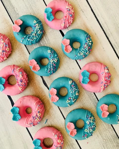 Pink and teal donuts with sprinkles for a Stitch-themed party.