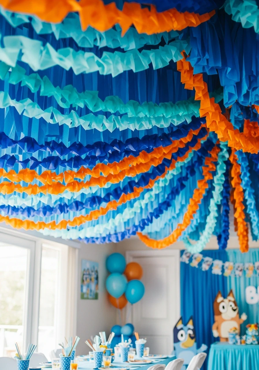 A ceiling covered in layers of blue and orange party streamers for a Bluey-themed birthday party.