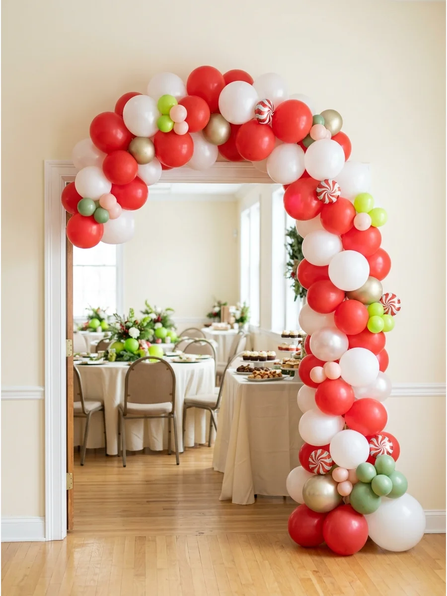 A red and white peppermint-style balloon arch.