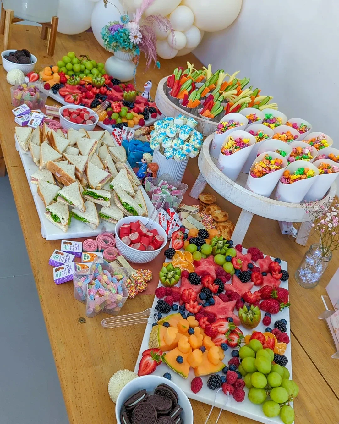 Vibrant Rainbow Grazing Table unicorn birthday party ideas