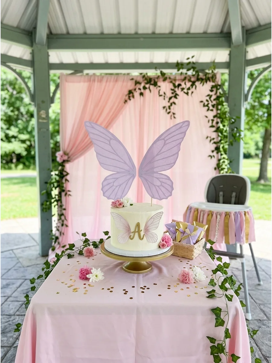 A white smash cake with lavender fairy wings attached to the back.