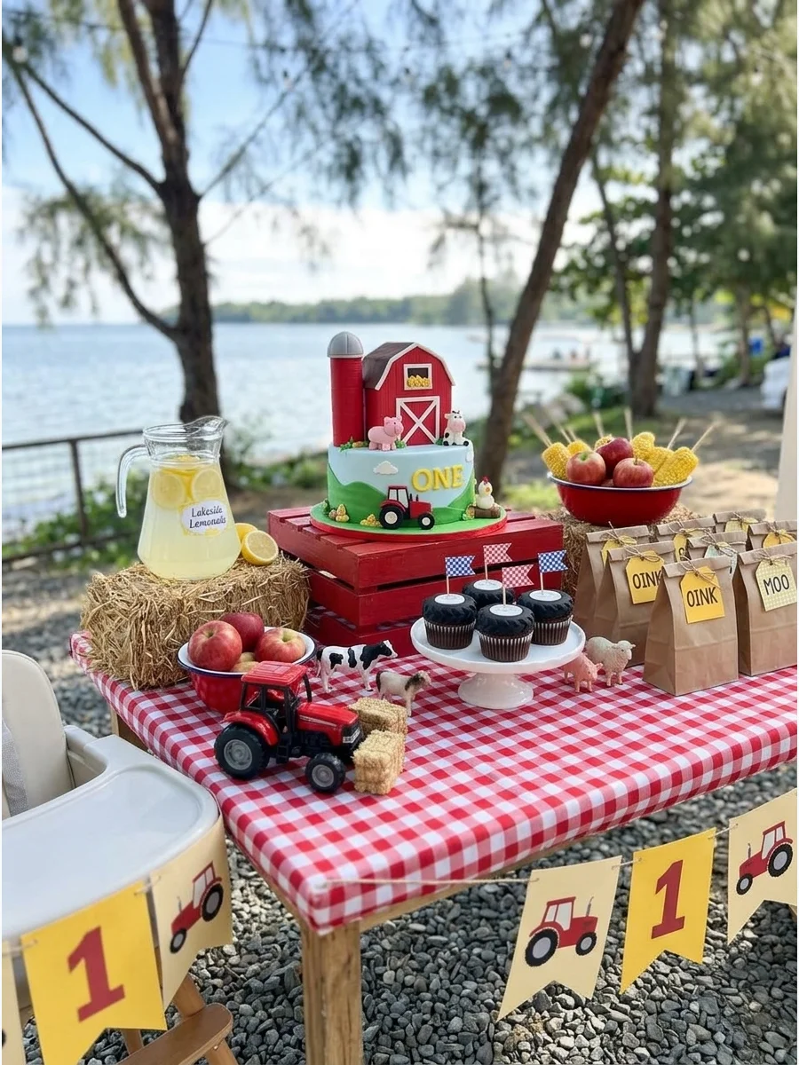 A farm themed birthday party with a red barn backdrop and yellow decorations.