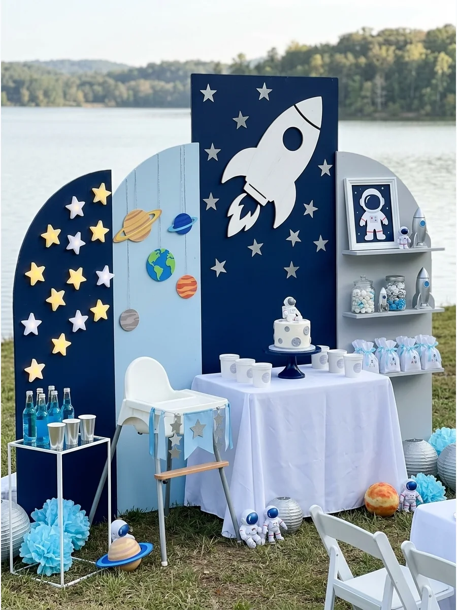 A space themed birthday party with navy blue walls and silver star decorations.