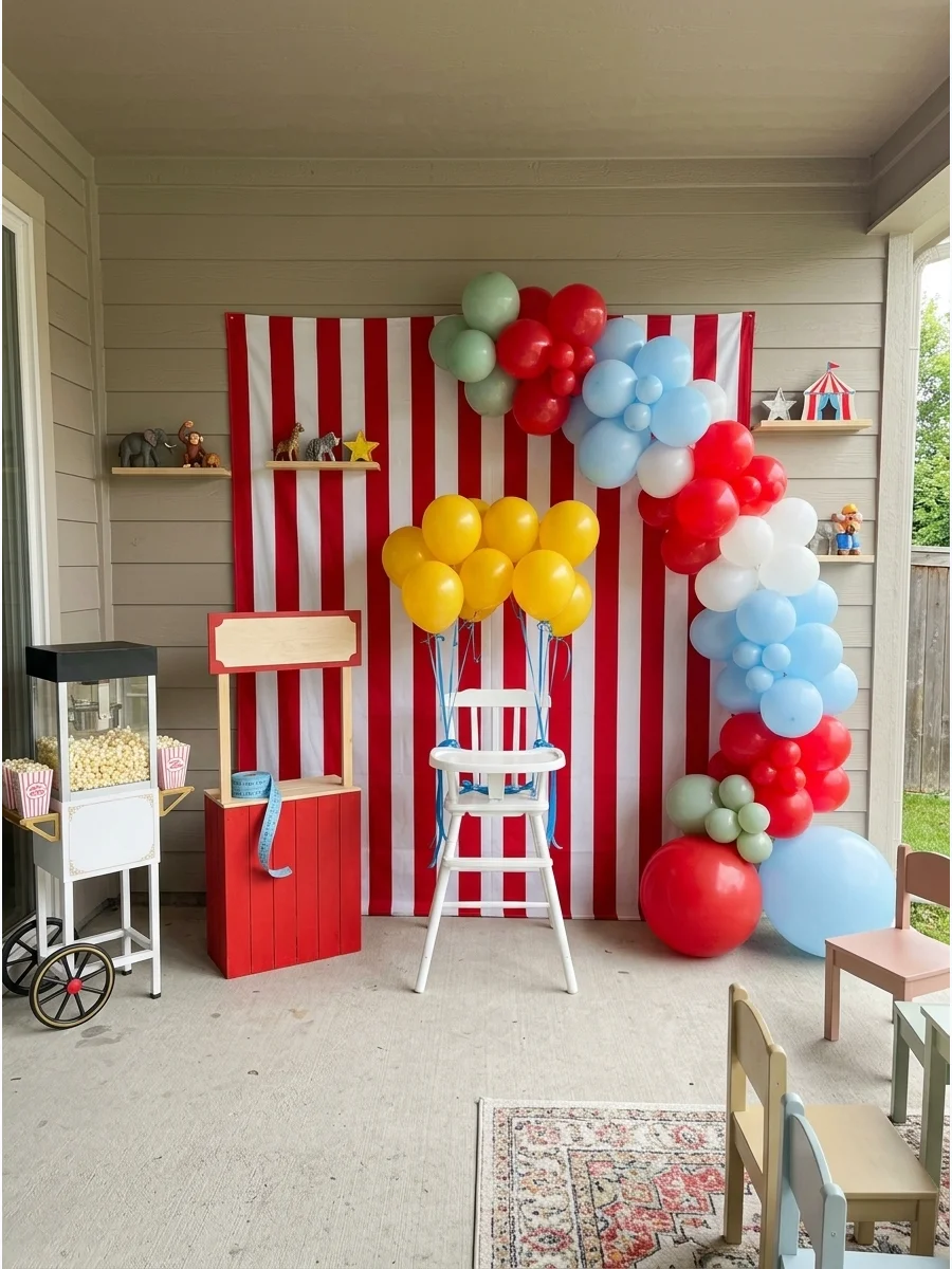 A circus themed first birthday setup with striped backdrop and balloons.