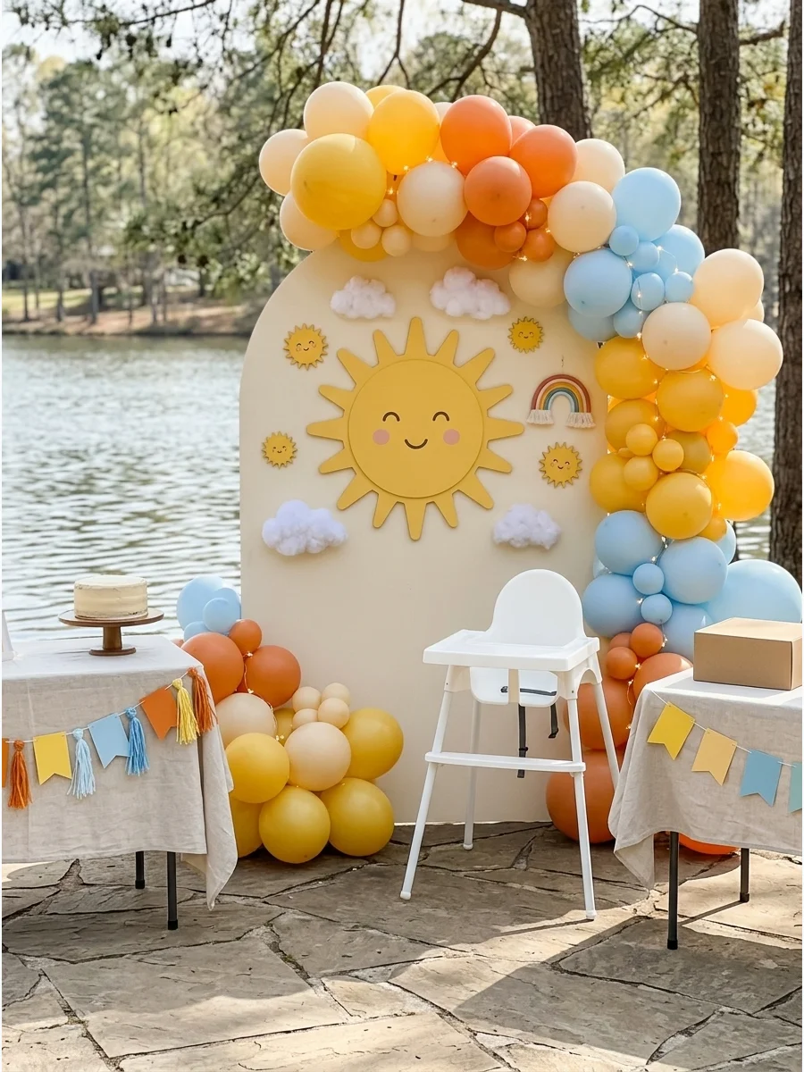Sun themed first birthday party with warm yellow and orange decorations.