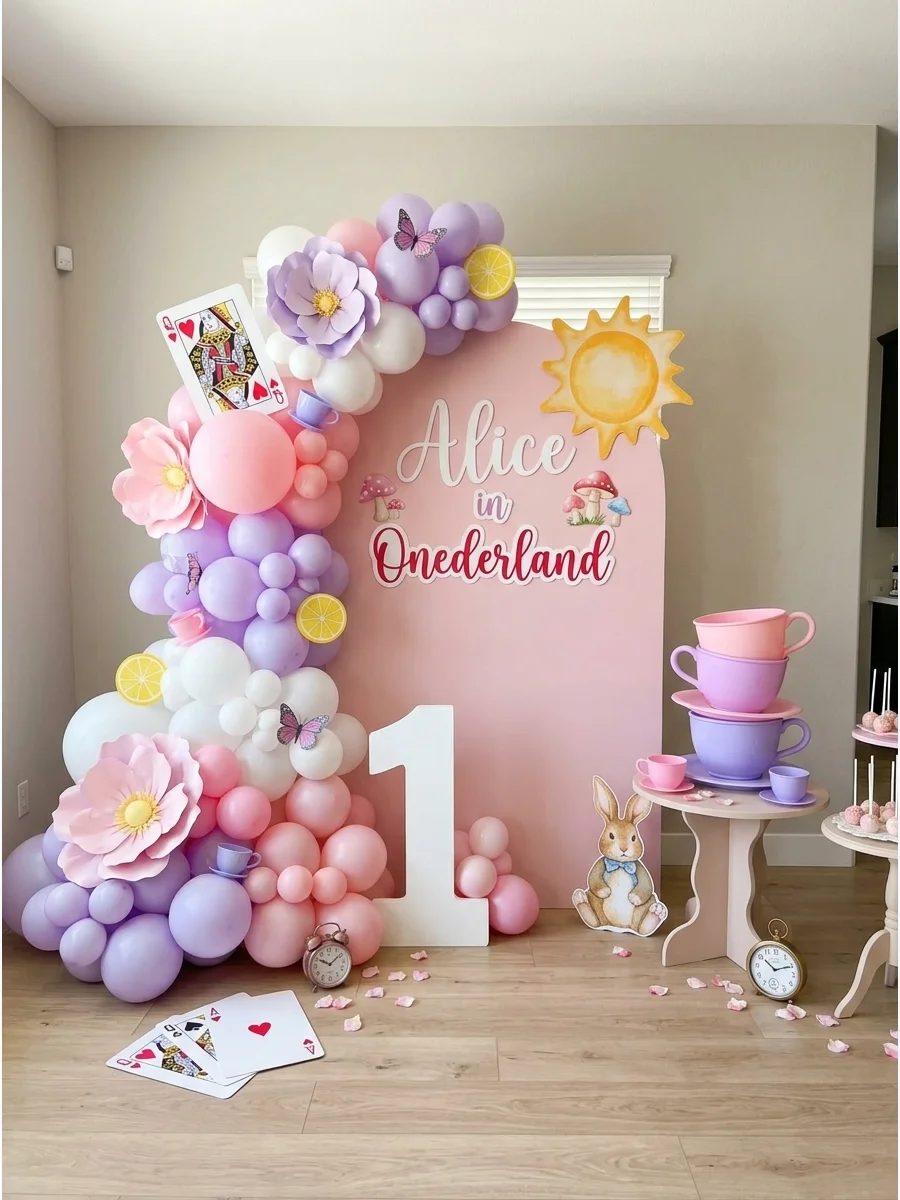 A whimsical Alice in Onederland tea party setup with pastel colors.