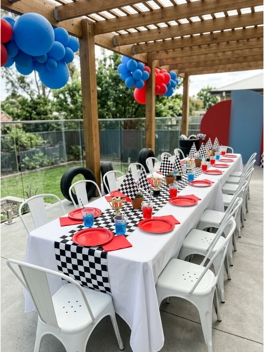 Guest table setup with checkered runner and red party plates.