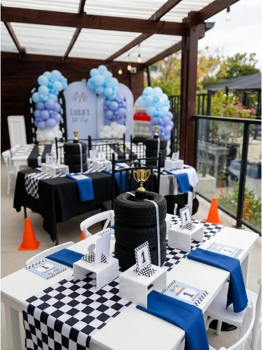 Centerpiece made of stacked small black tires and a gold trophy.
