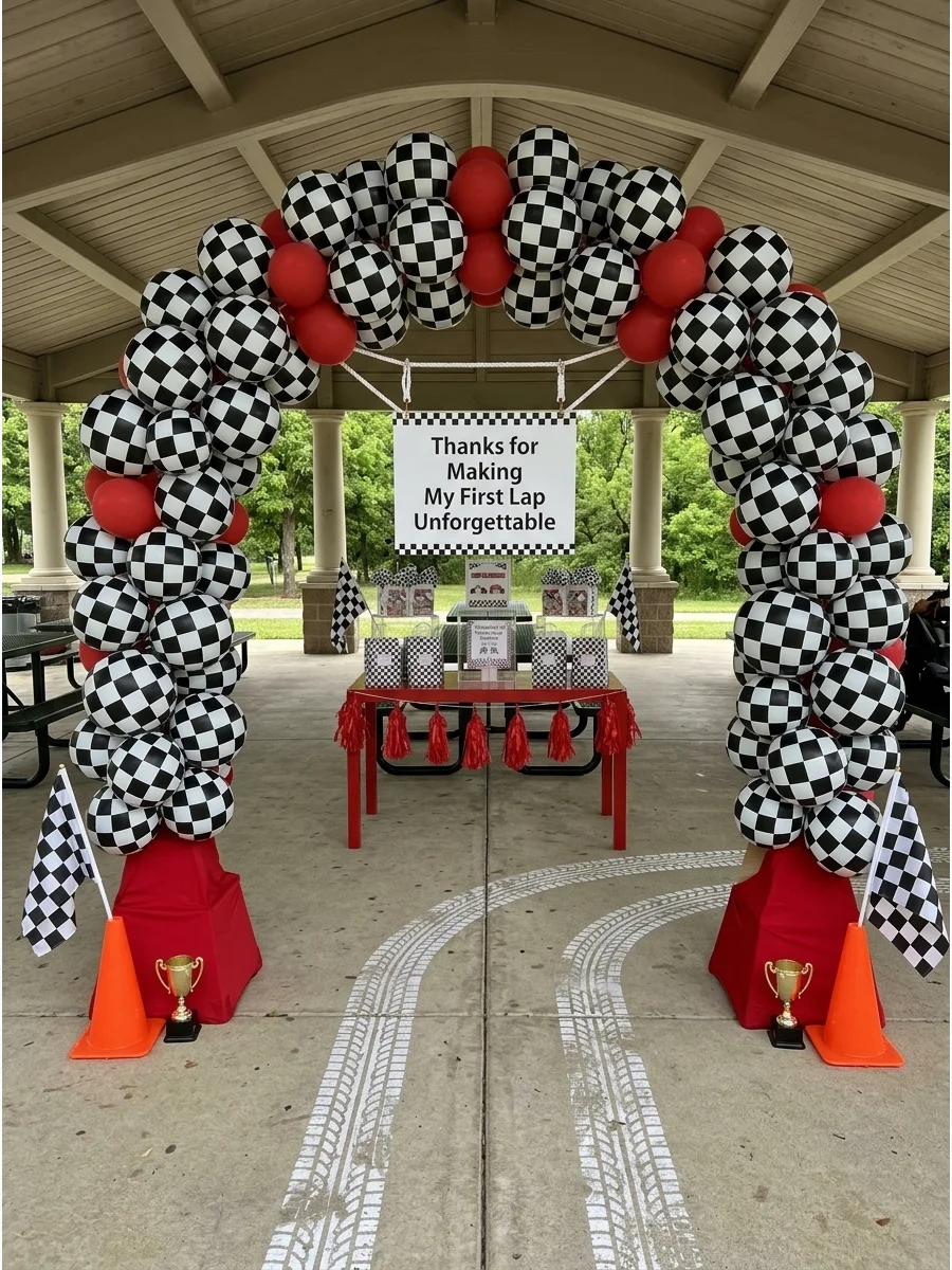A checkered balloon arch over a doorway with a thank-you sign for a first birthday party.