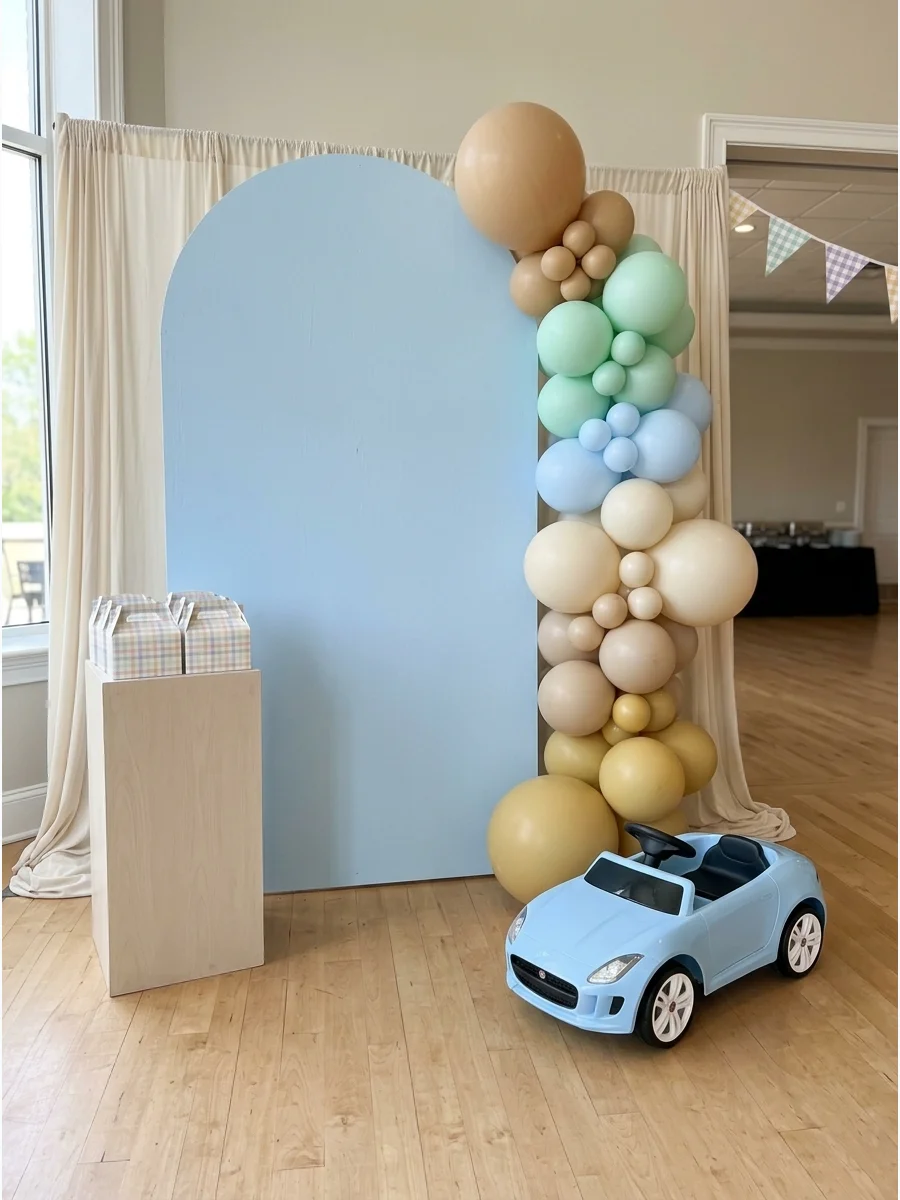A pastel racing theme setup with soft blue and mint colors for a first birthday.