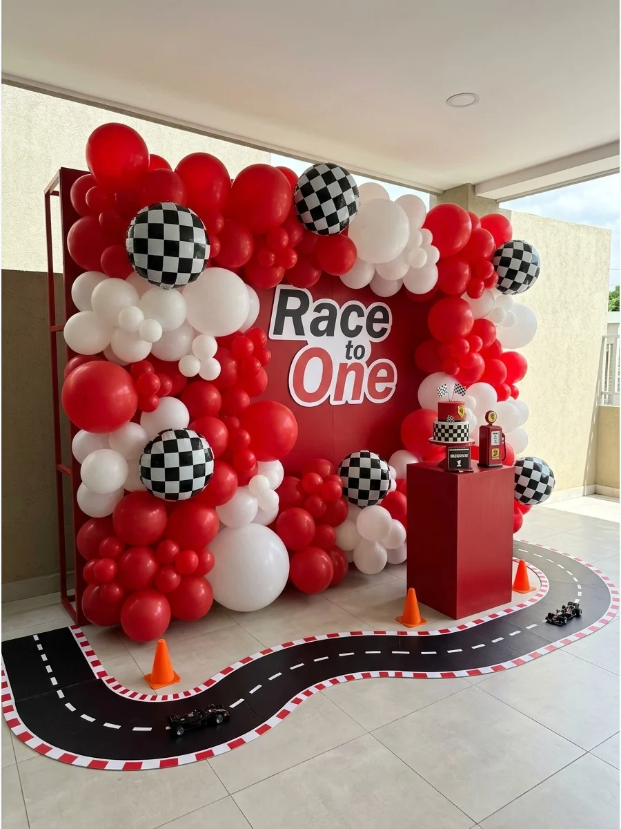 A large balloon wall with a paper road track for a racing-themed party.