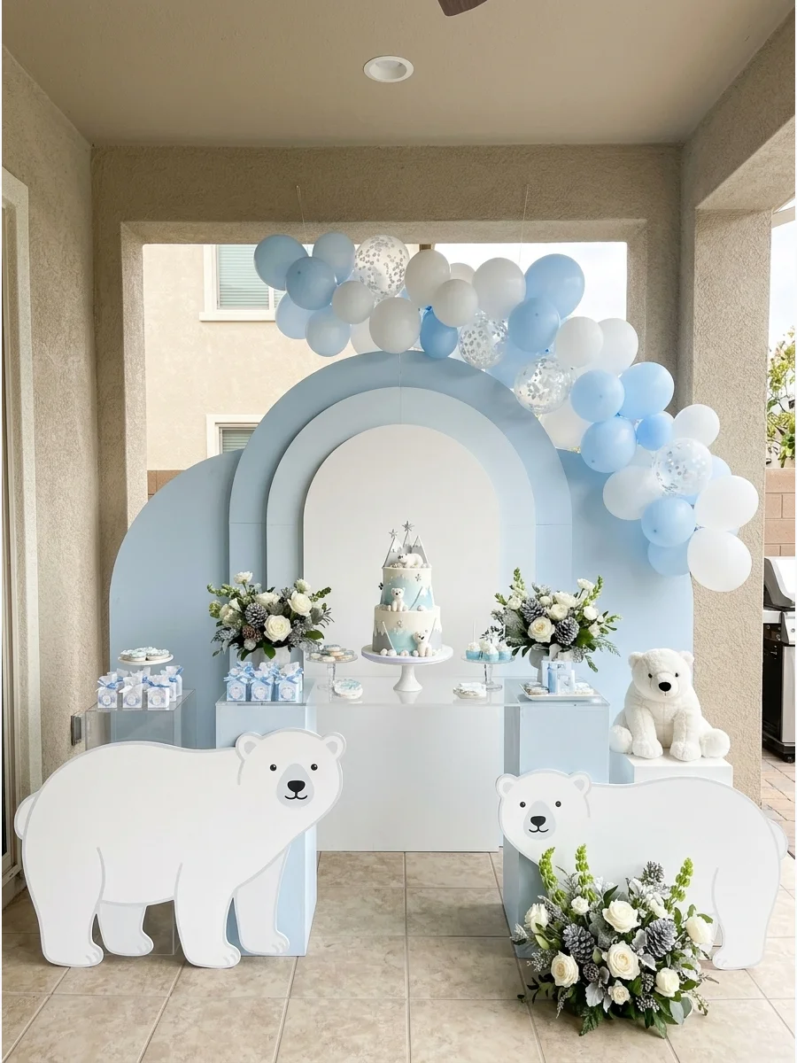 A layered arch backdrop in blue and white with polar bear cutouts.