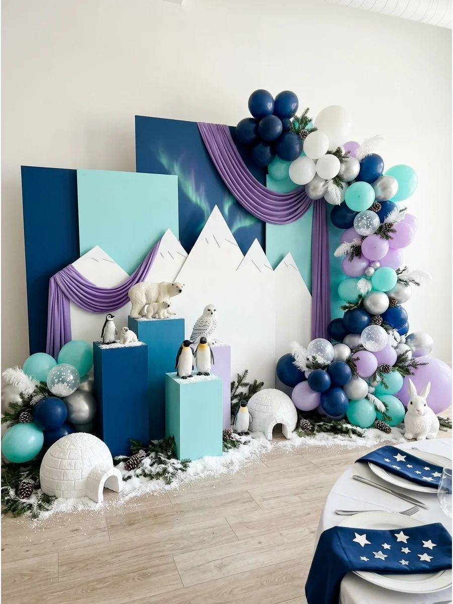 A photo booth area with purple drapes and white mountain cutouts.