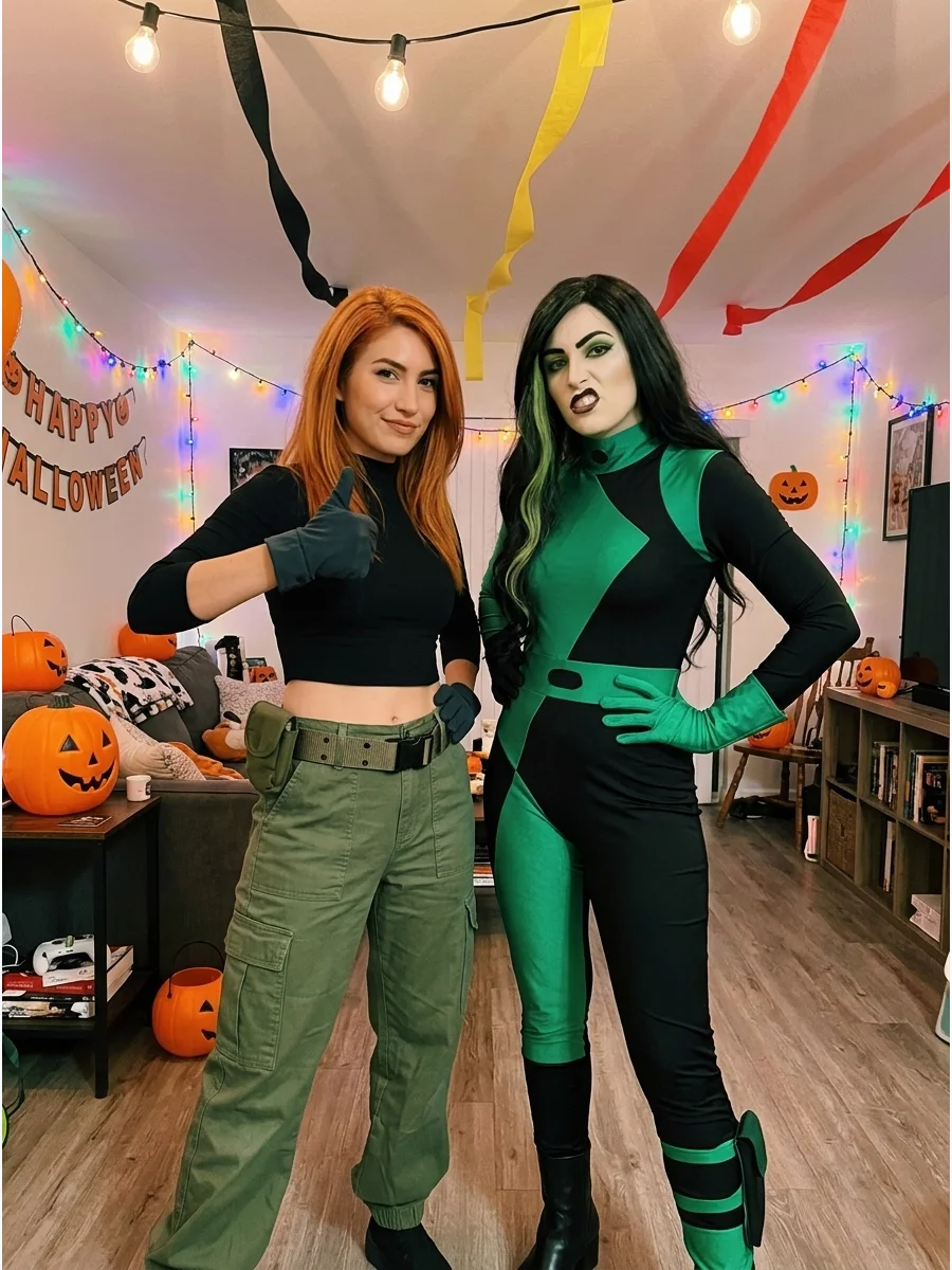Kim Possible and Shego. Kim can wear green cargo pants and a black fitted top while Shego wears a black-and-green outfit with long dark hair. Coordinated gloves and dramatic poses