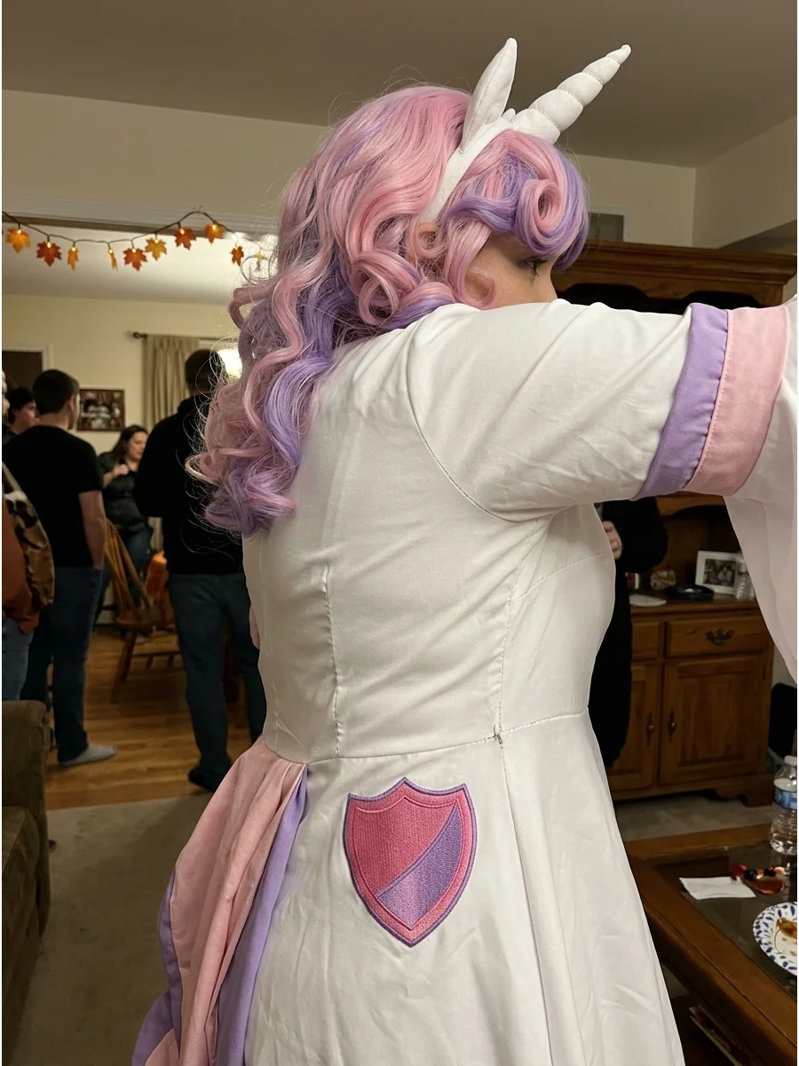 Sweetie Belle Costume. Wear a white outfit with pale pink and purple accessories for a cute Sweetie Belle costume. Complete it with a curled pastel wig, unicorn horn, and shield-sh