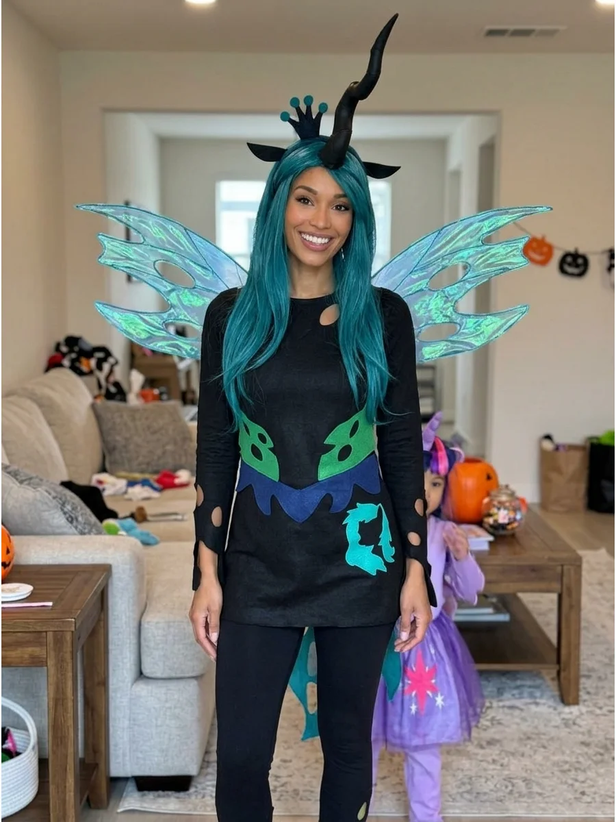Queen Chrysalis Costume. Wear a black outfit with translucent blue-green wings for a dramatic Queen Chrysalis costume. Add a teal wig, dark crown, long horn, and cutout-style detai