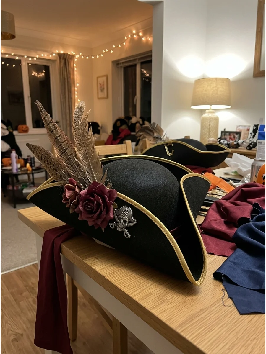 DIY Pirate Hat Costume. Create a tricorn hat from black felt, craft foam, or a reshaped wide-brim hat. Decorate it with gold edging, feathers, fabric flowers, or a handmade pirate