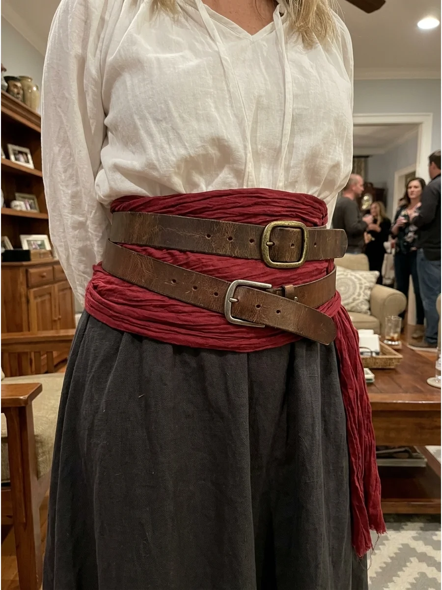 DIY Pirate Belt and Sash Costume. Layer two or three belts over a long red sash to create the center of the outfit. Combine them with a white blouse, dark skirt, boots, and a scarf