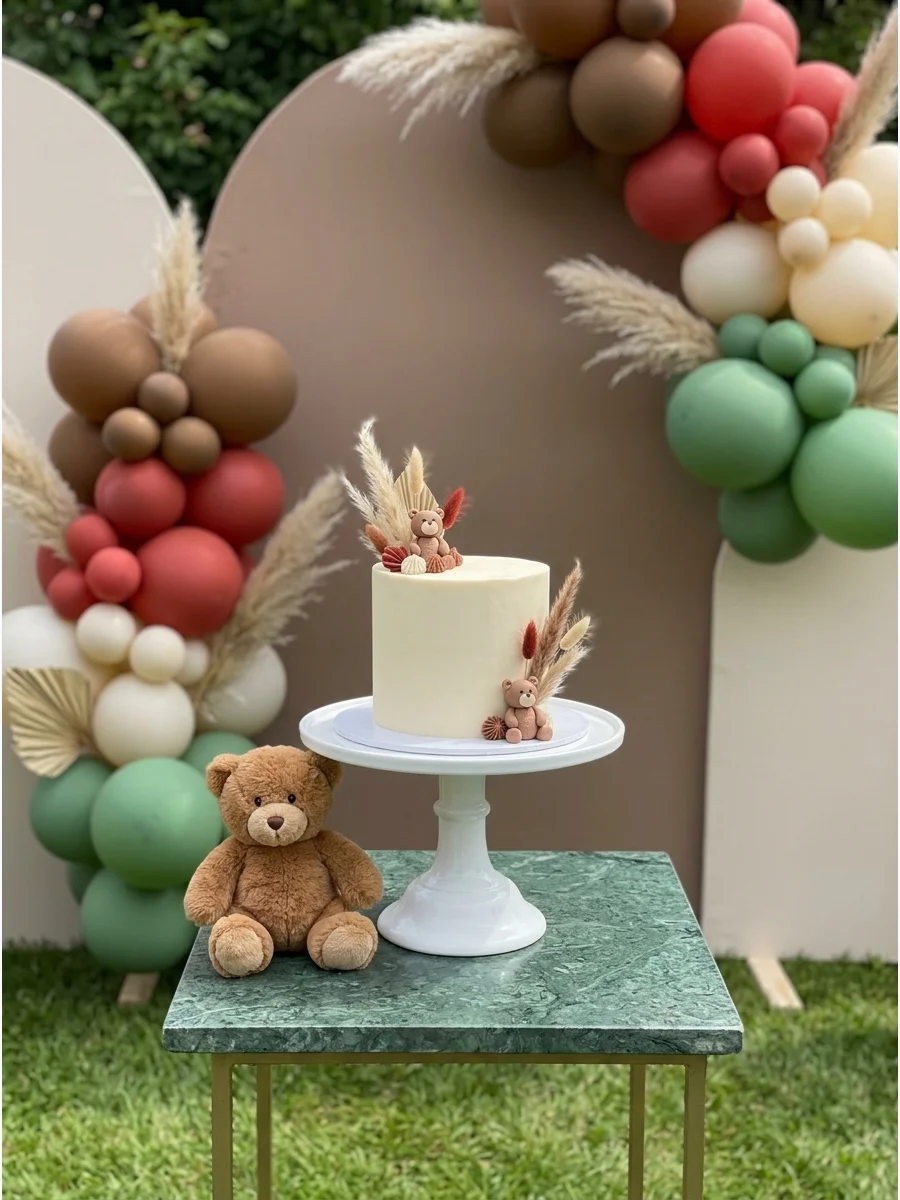 A wooden arch backdrop with a teddy bear pun and balloon clusters.