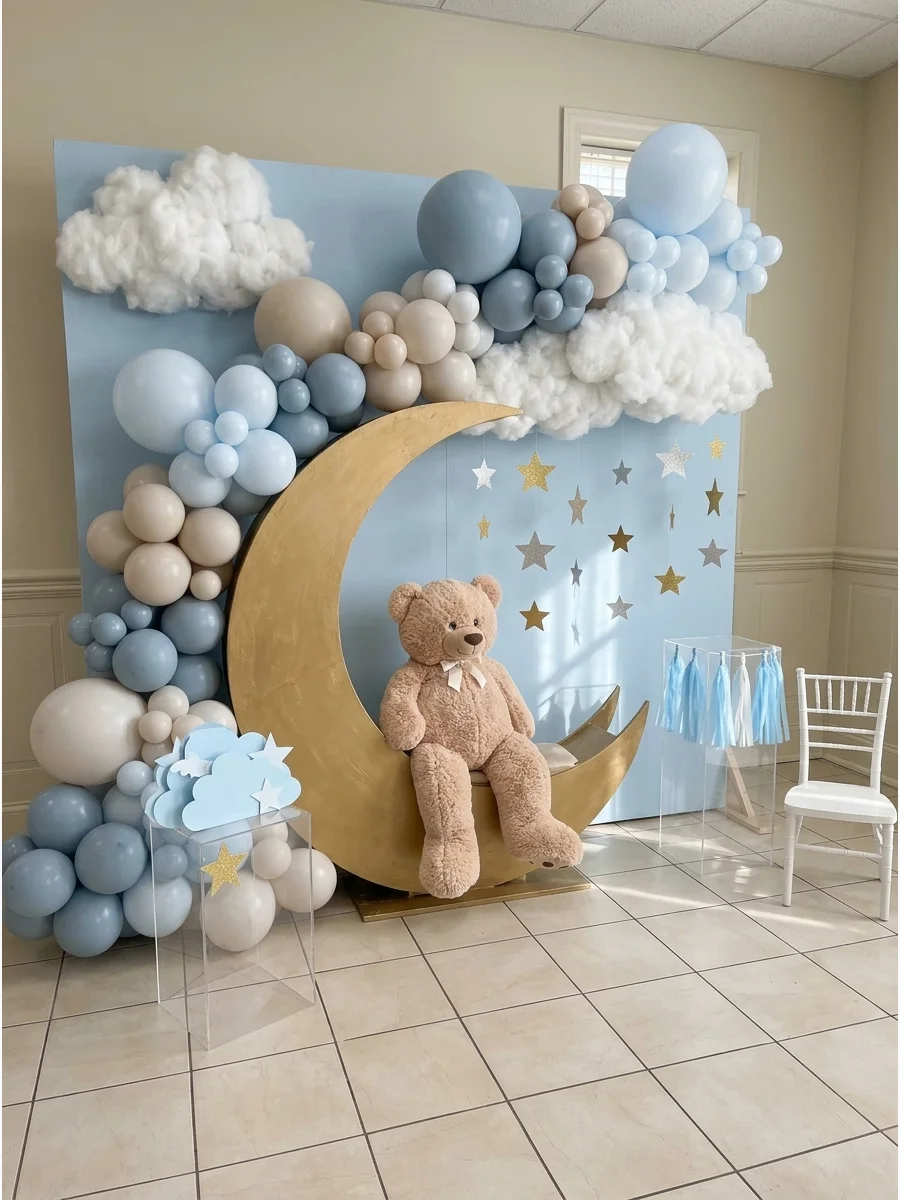 A dreamy cloud and moon backdrop featuring a plush teddy bear.