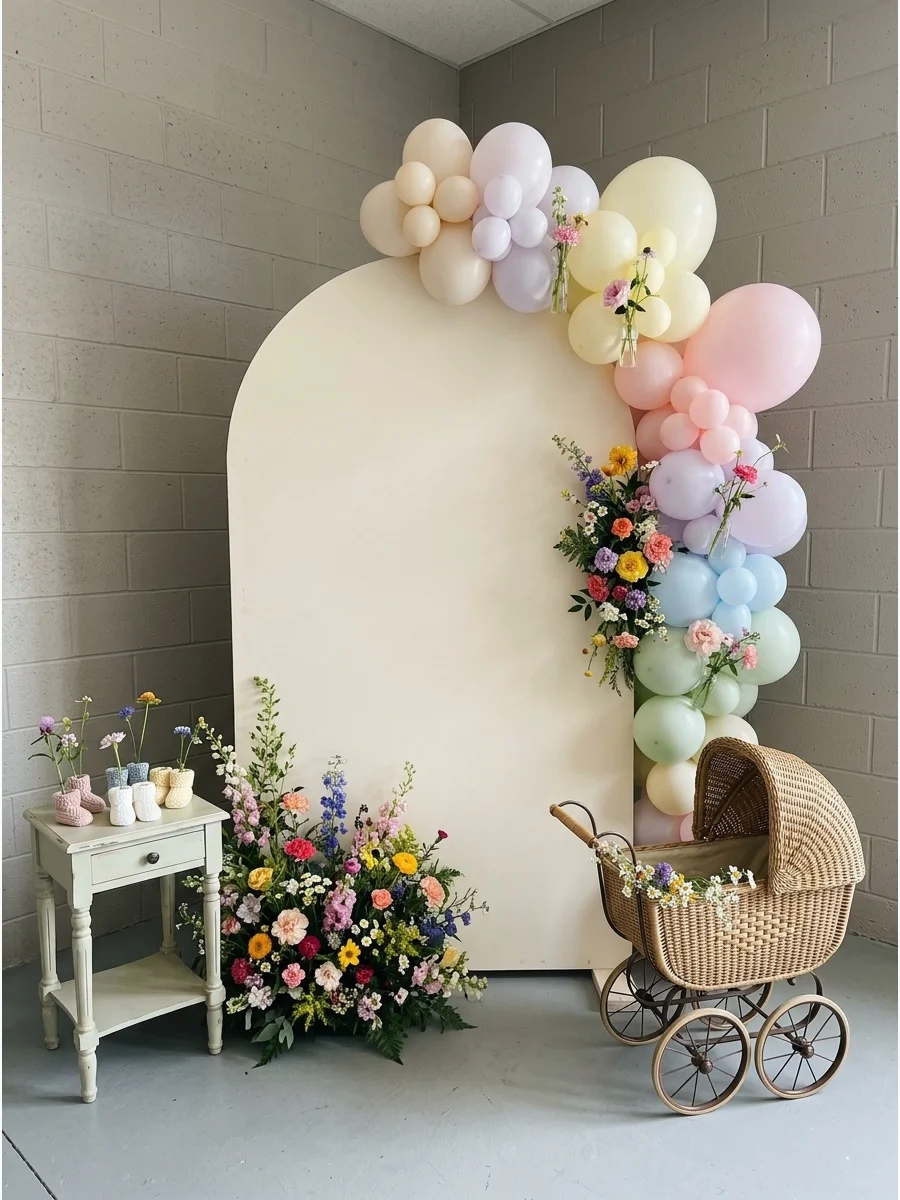 A cream arched backdrop with wildflower lettering and floral clusters.