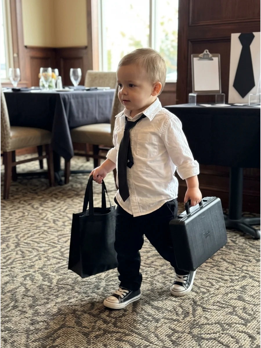 Toddler in a suit and sneakers for Halloween.