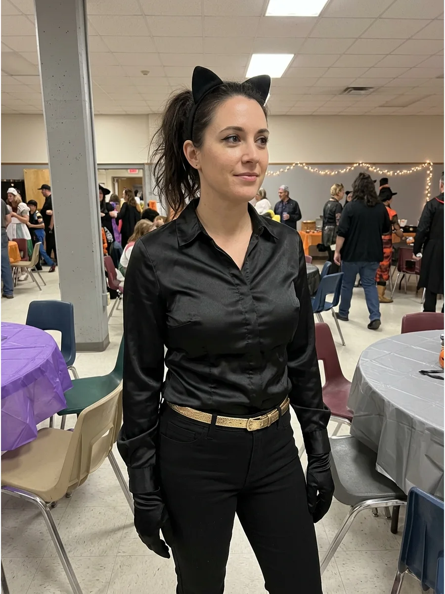 Satin Catwoman Costume. Use a black satin blouse or jumpsuit for a smoother, more elegant interpretation. Add fitted pants, gloves, a gold belt, and a small cat-ear headband. Catwo
