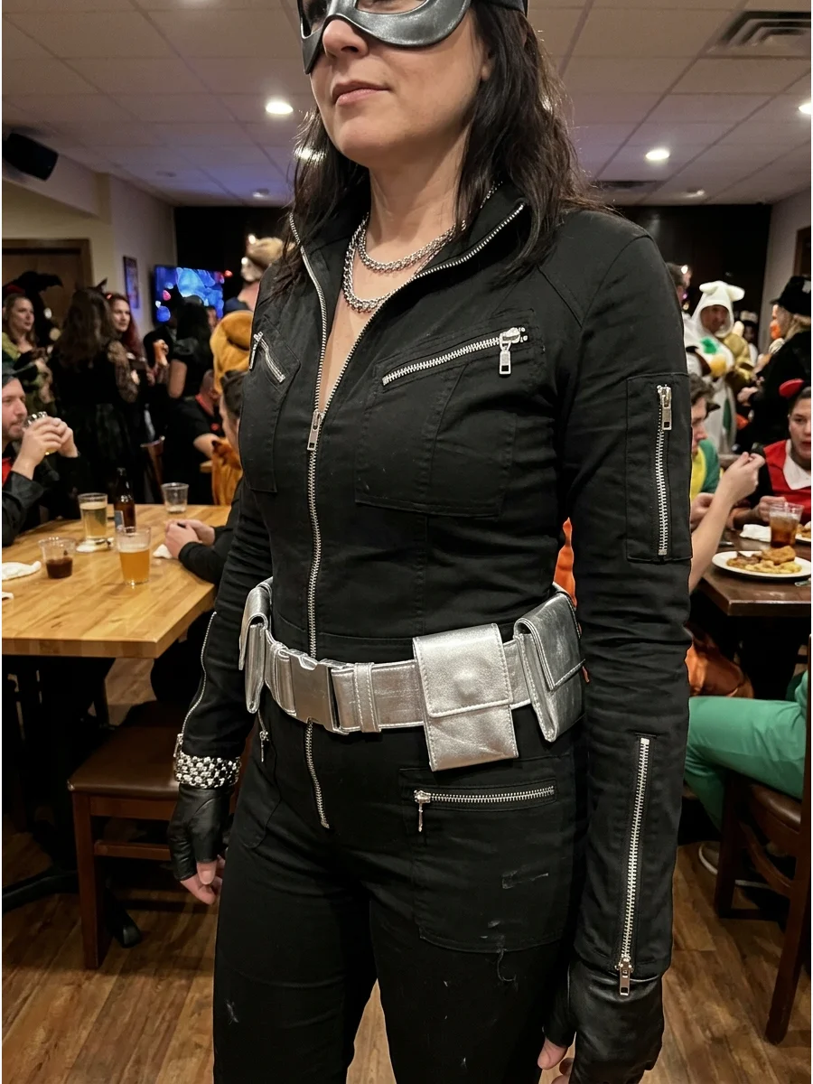 Black-and-Silver Catwoman Costume. Add silver zippers, a silver belt, or metallic costume jewelry to an all-black outfit. The silver details make a basic costume appear more modern