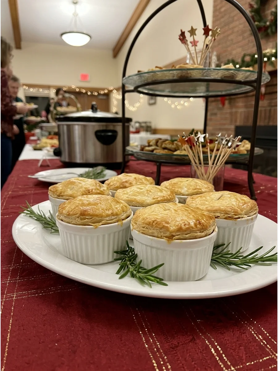 Individual mini chicken pot pies arranged on a white serving platter.