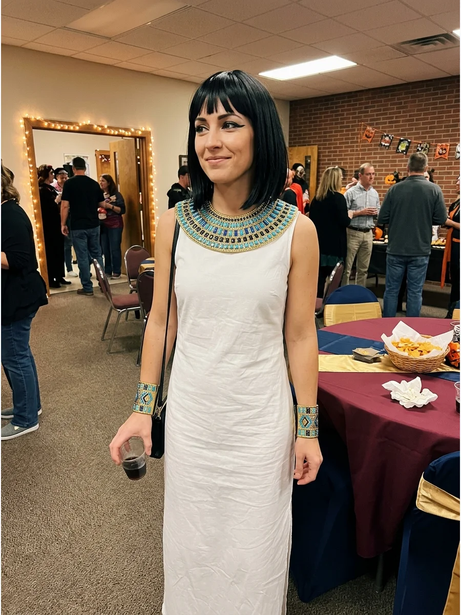 Minimalist Cleopatra Costume. Wear a simple black or white column dress with one wide gold collar and matching cuffs. Finish the look with winged eyeliner and a sleek center-parted
