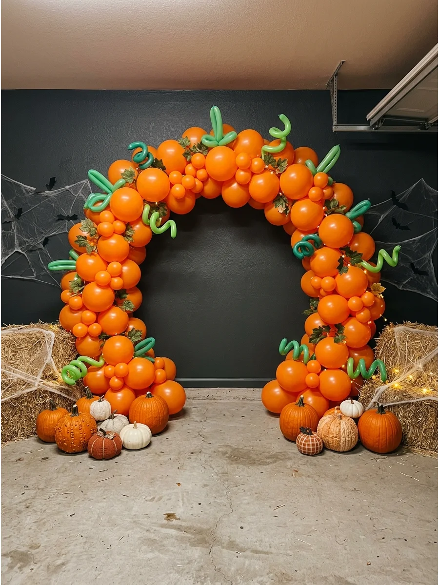 A large orange balloon arch shaped like pumpkins with green balloon vines.